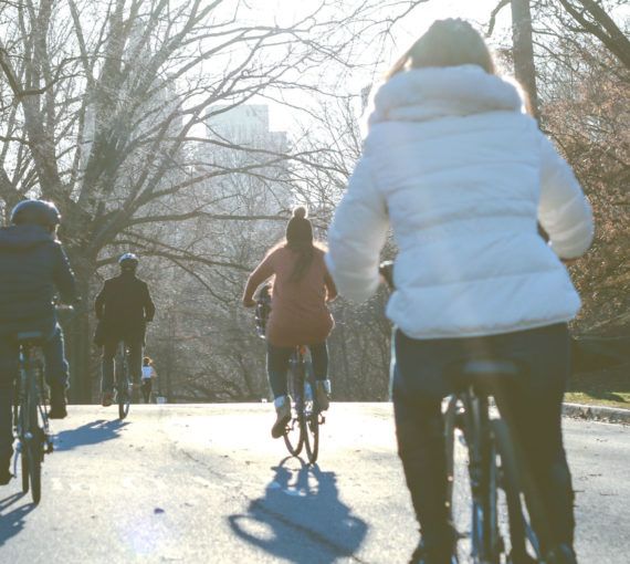 Family cycling down a road