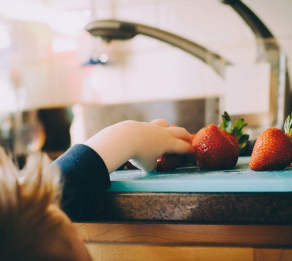 washing-fruit-strawberries Child reaching for a washed strawberry
