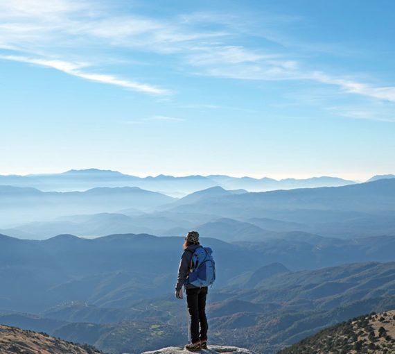 Woman standing at horizon's edge