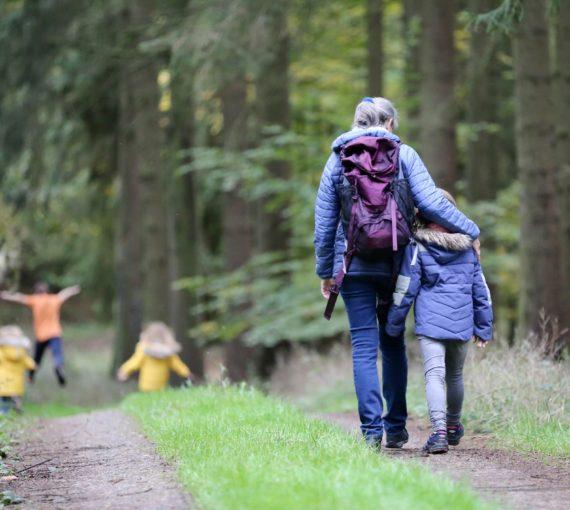Woman and family walking in a forest