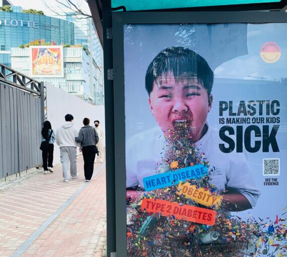 Bus stop sign reading 'plastic is making our kids sick'