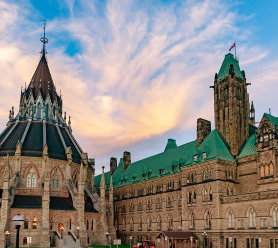 sunsetting cloudy sky behind Canadian buildings